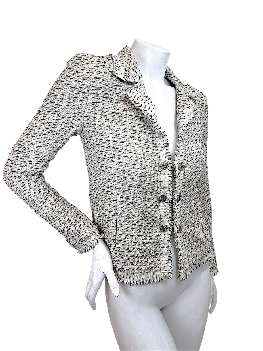 Angled front view of Chanel 2004 fitted Lesage tweed jacket with fringe trim and tailored silhouette