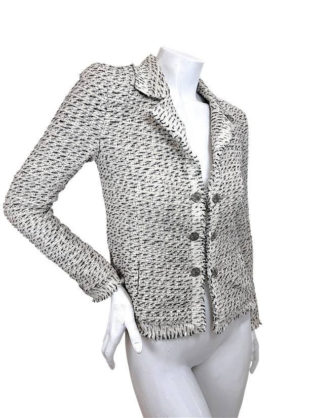 Angled front view of Chanel 2004 fitted Lesage tweed jacket with fringe trim and tailored silhouette