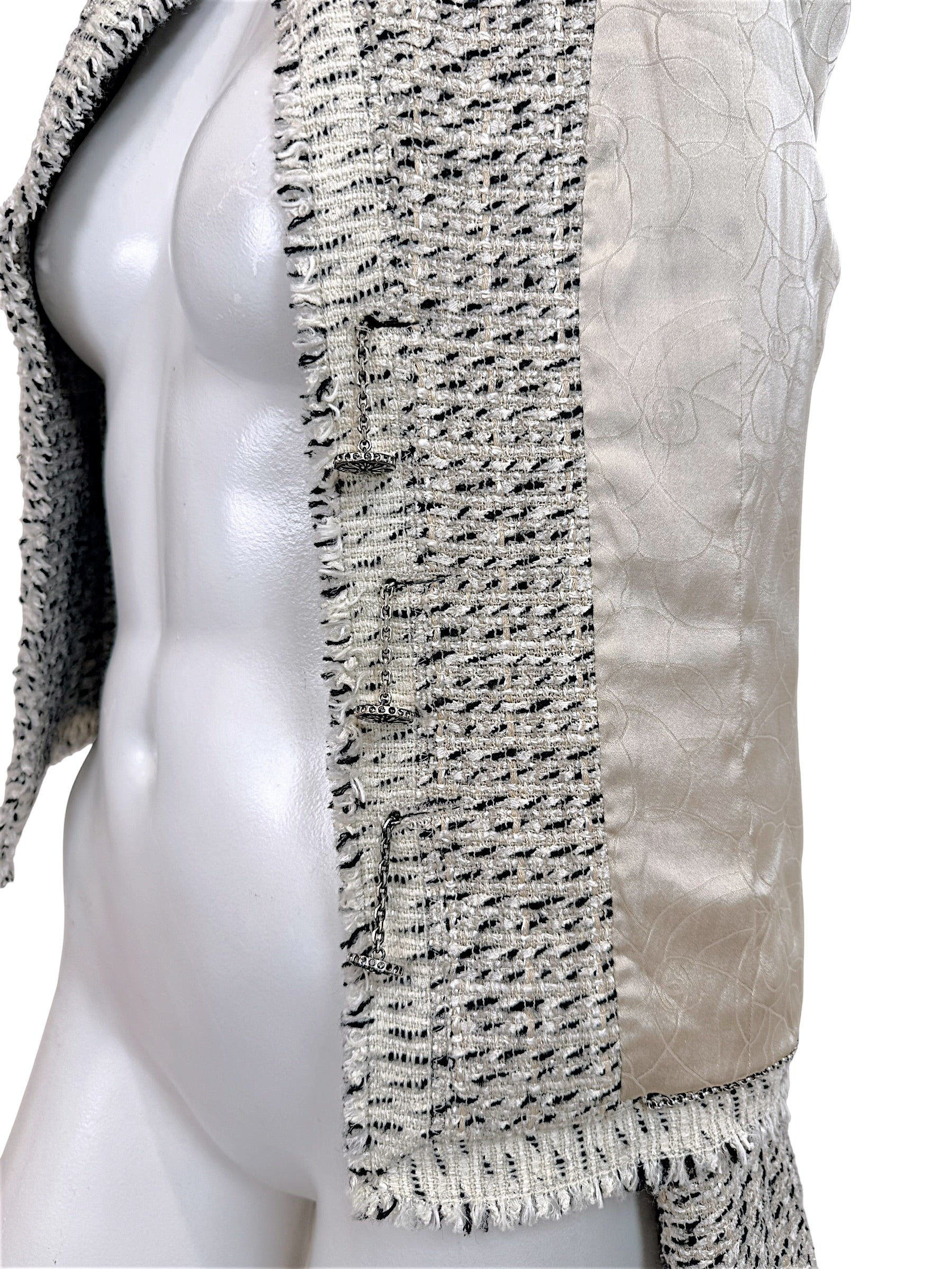 Side interior detail of Chanel 2004 Lesage tweed jacket showing signature weighted chain and silk lining
