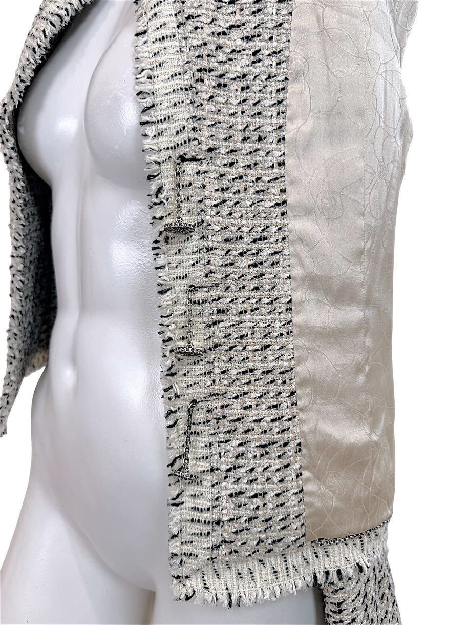 Side interior detail of Chanel 2004 Lesage tweed jacket showing signature weighted chain and silk lining