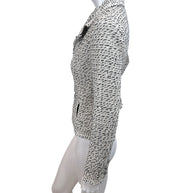 Left side profile of Chanel 2004 ivory black Lesage tweed jacket with structured tailoring and fringe hem