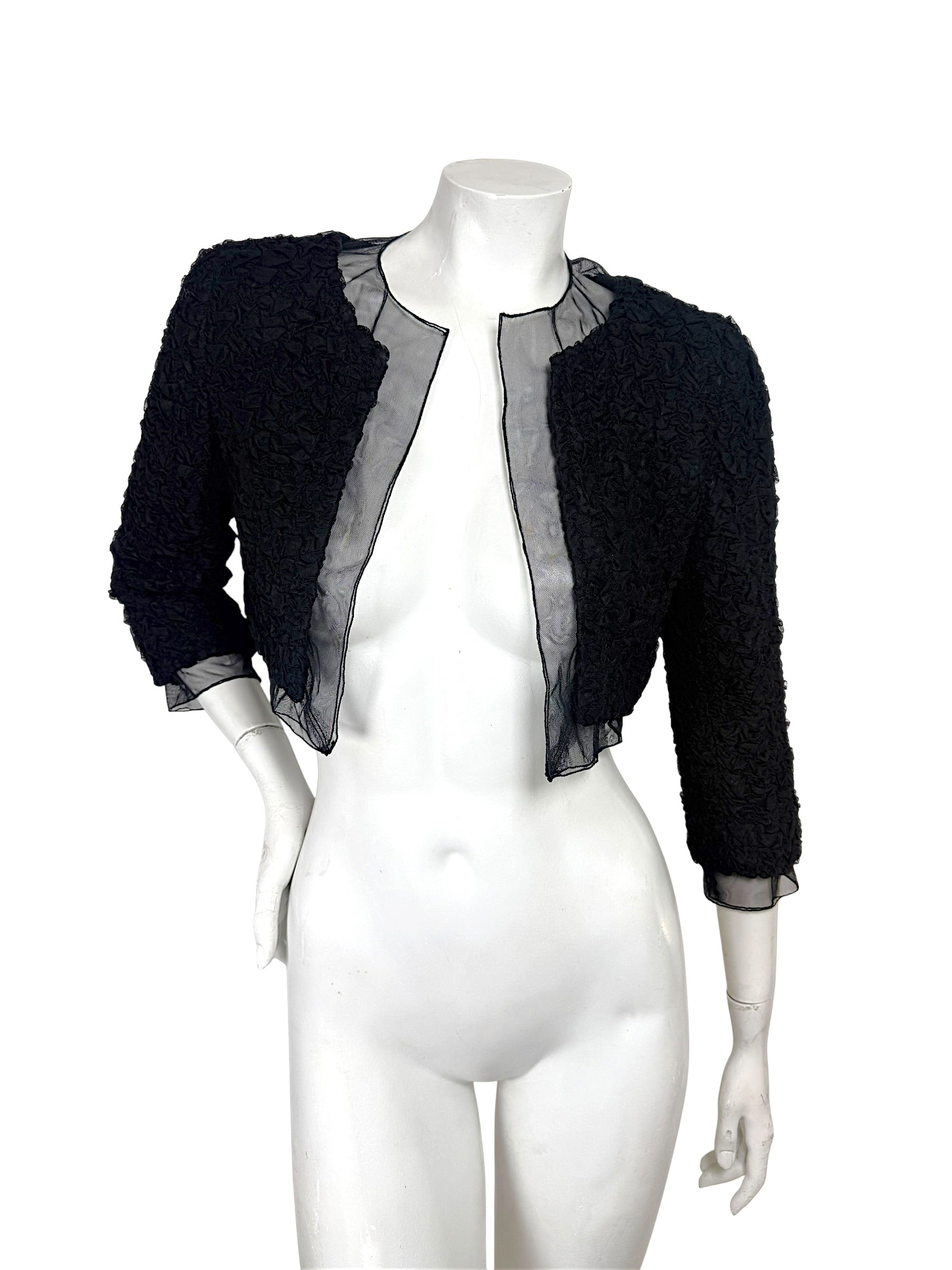 Full front view of Chanel black cropped bolero jacket with ruched texture and sheer silk chiffon panels