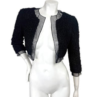 Full front view of Chanel black cropped bolero jacket with ruched texture and sheer silk chiffon panels