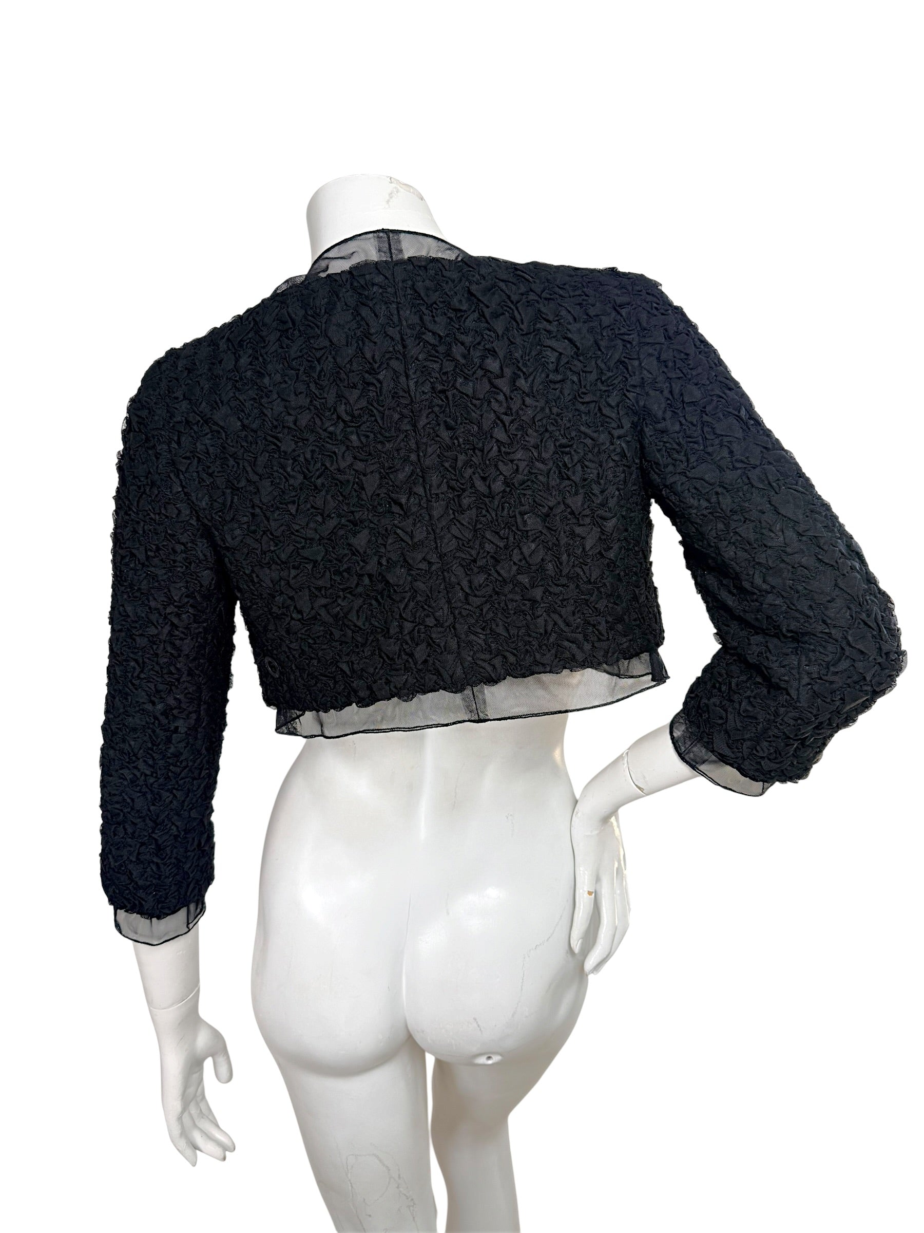 Back view of Chanel cropped ruched jacket with sheer chiffon hem and textured fabric detail