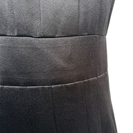 Close-up fabric detail of vintage Chanel black satin dress showing texture and subtle sheen.
