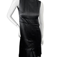 Angled front view of vintage Chanel black satin pleated cocktail dress with architectural tailoring.