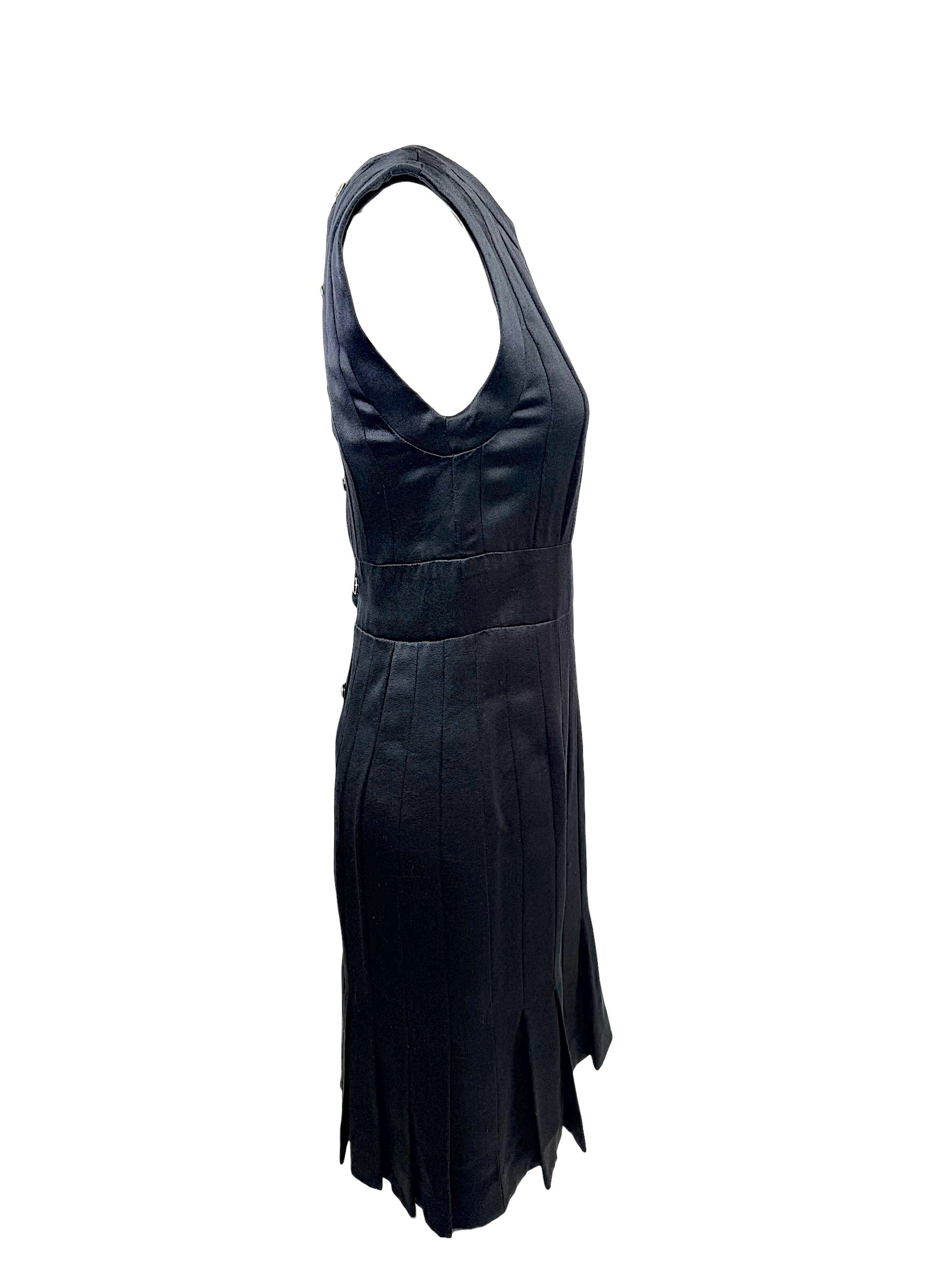 Left side profile of vintage Chanel black satin sleeveless dress with flared pleated hem.