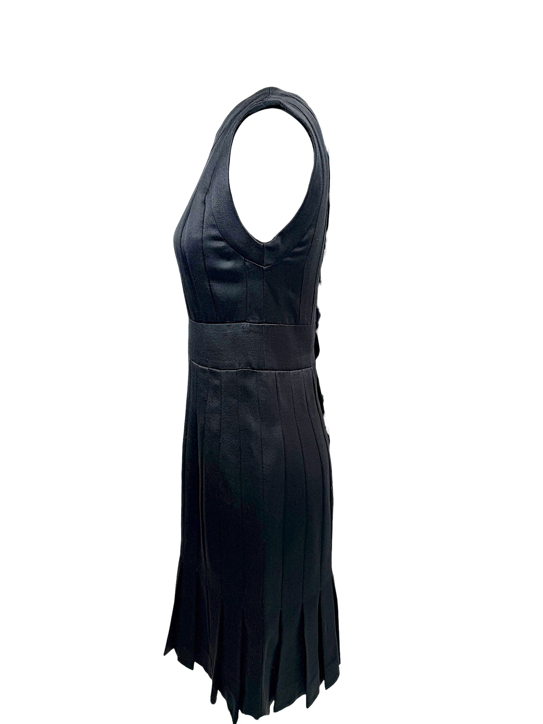Right side profile of vintage Chanel satin pleated dress with structured silhouette and flared hem.