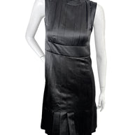 Vintage Chanel black satin sleeveless pleated dress front view with sculpted neckline and fitted waist detail.