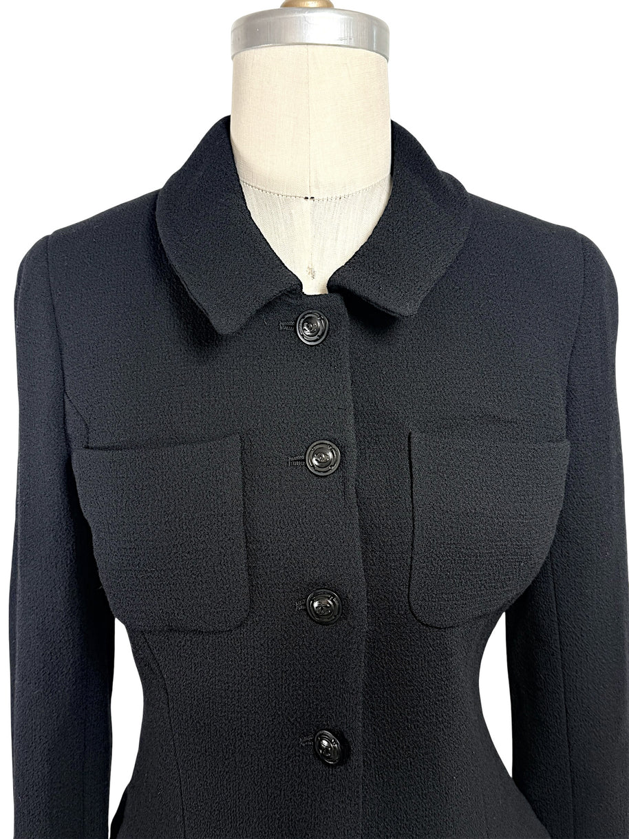 Close-up front detail of vintage Chanel black textured cropped jacket with tonal CC logo buttons