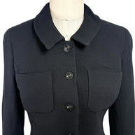 Close-up front detail of vintage Chanel black textured cropped jacket with tonal CC logo buttons