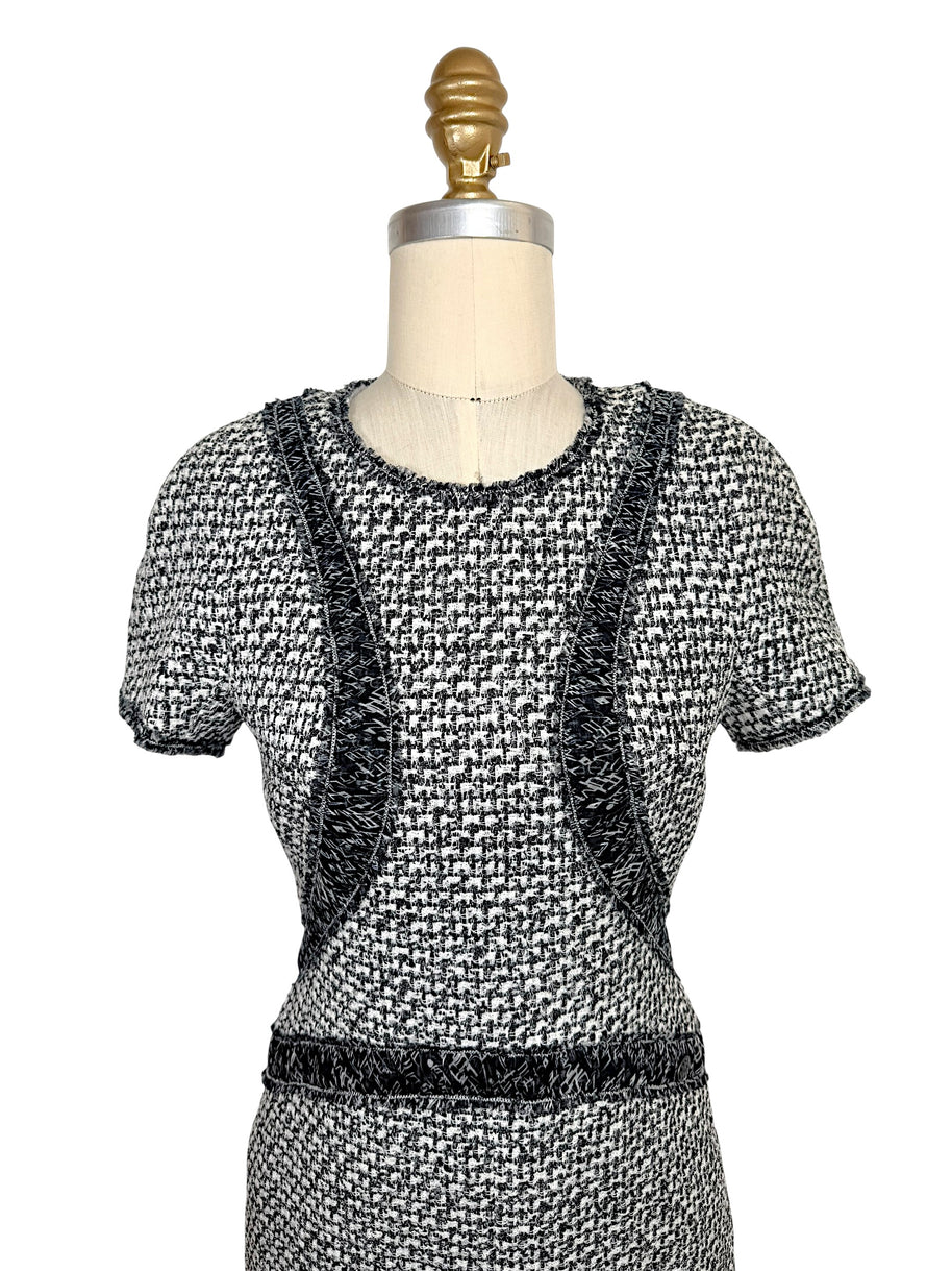 Front upper detail of Chanel black and white boucle tweed dress with ribbon trim