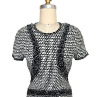 Front upper detail of Chanel black and white boucle tweed dress with ribbon trim
