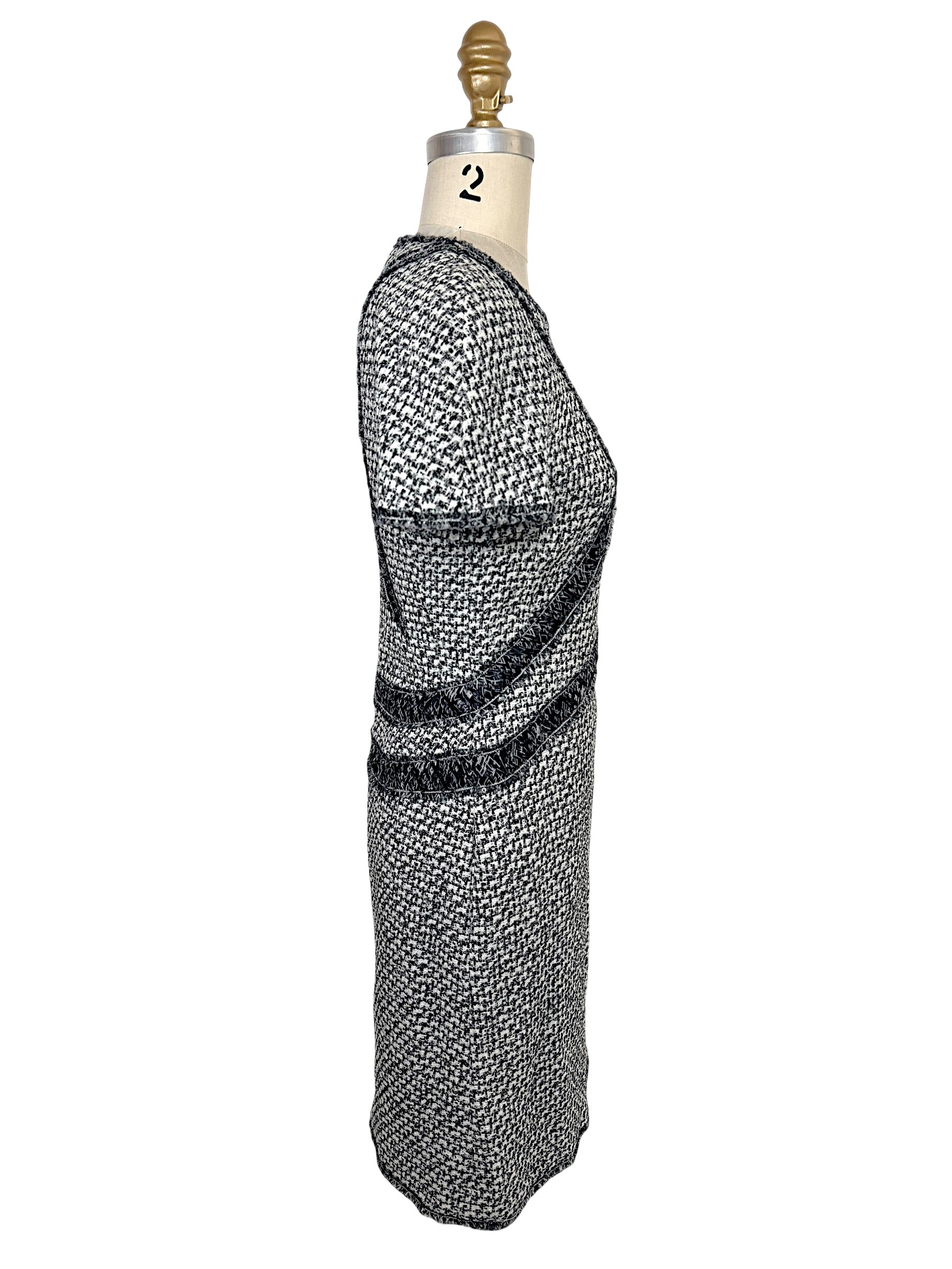 Left side profile of Chanel black and white tweed mini dress