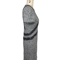 Left side profile of Chanel black and white tweed mini dress