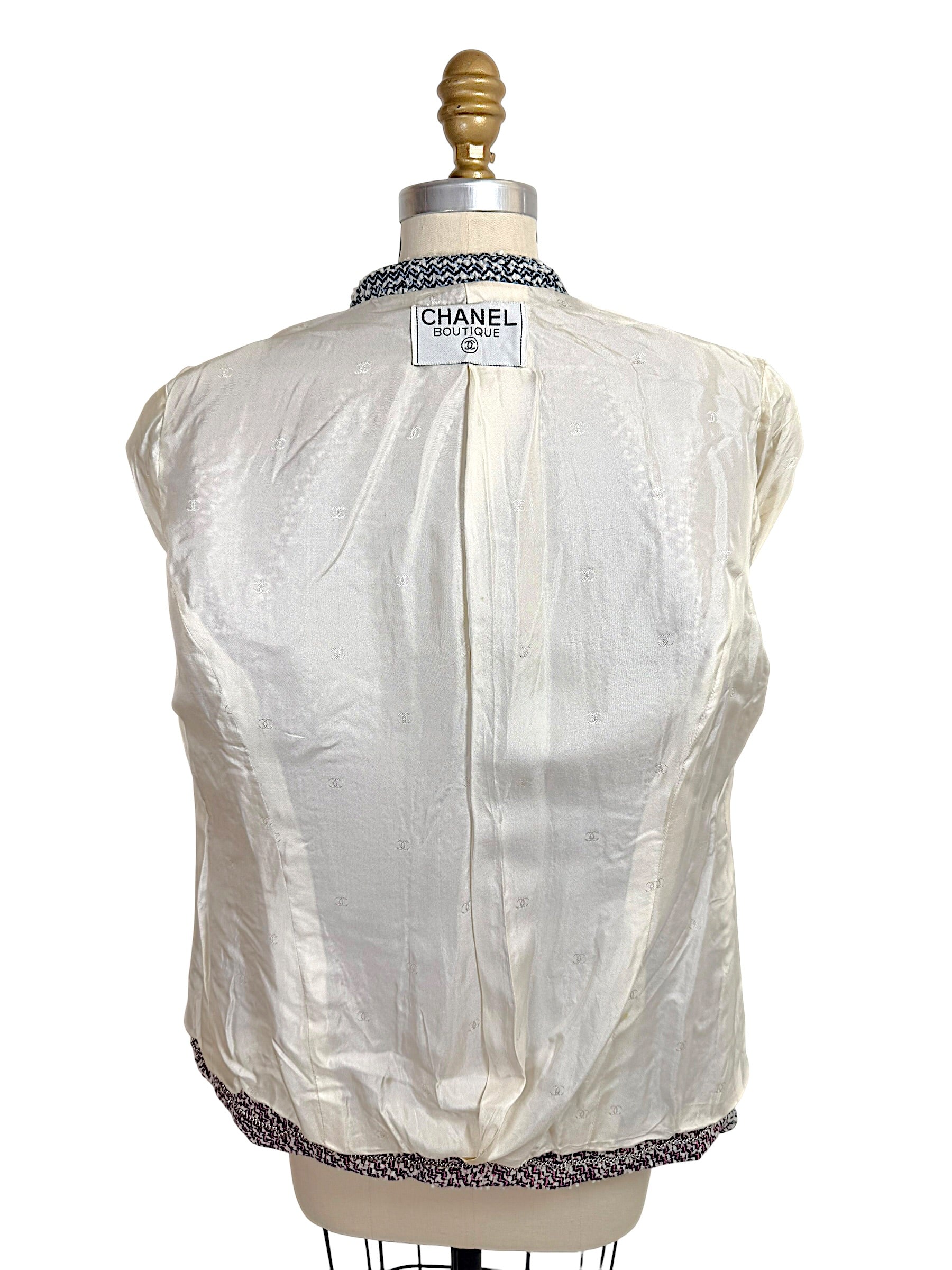 Interior silk CC logo jacquard lining of Chanel Boutique Spring 1996 tweed jacket with Chanel label visible