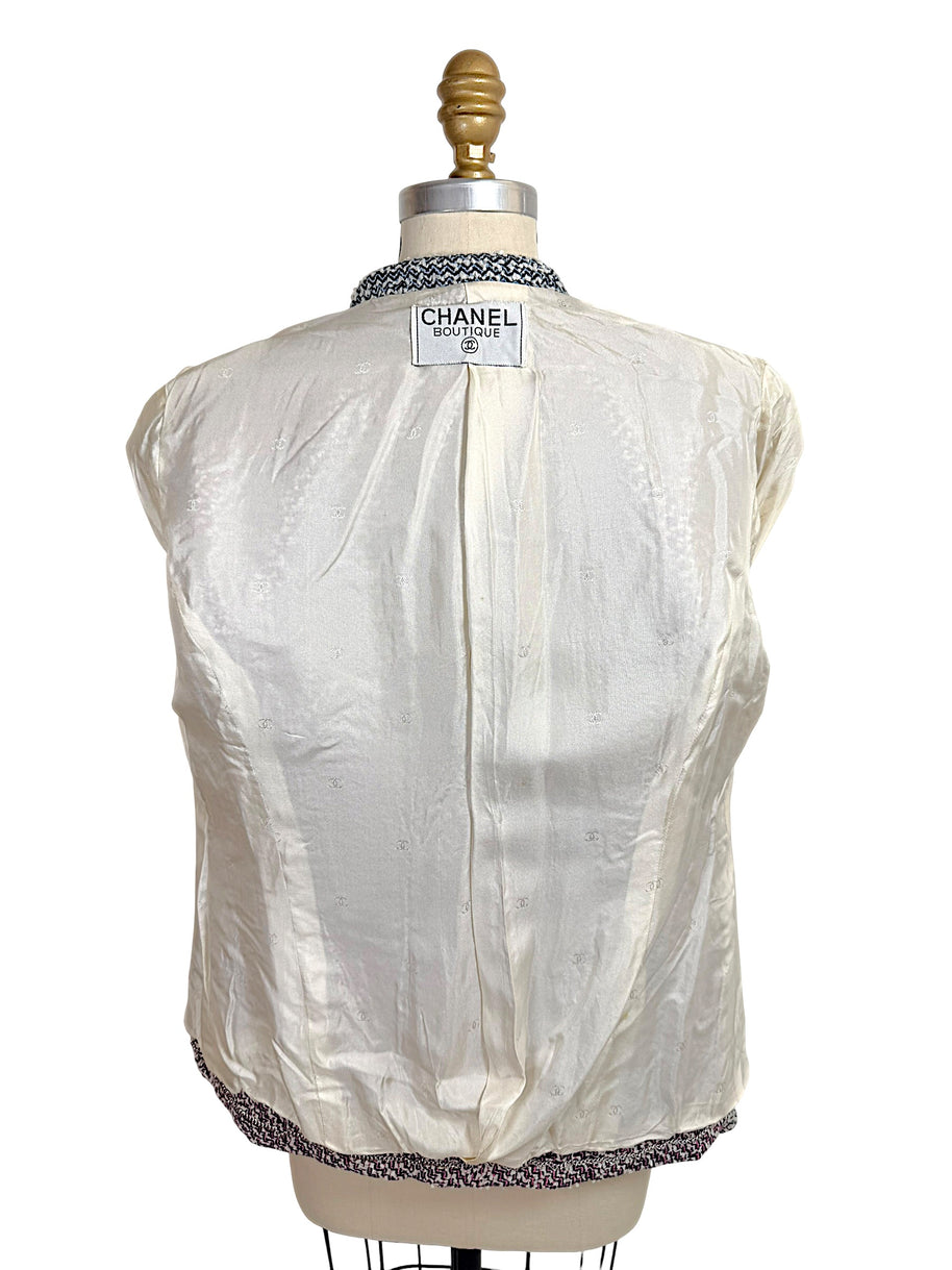 Interior silk CC logo jacquard lining of Chanel Boutique Spring 1996 tweed jacket with Chanel label visible