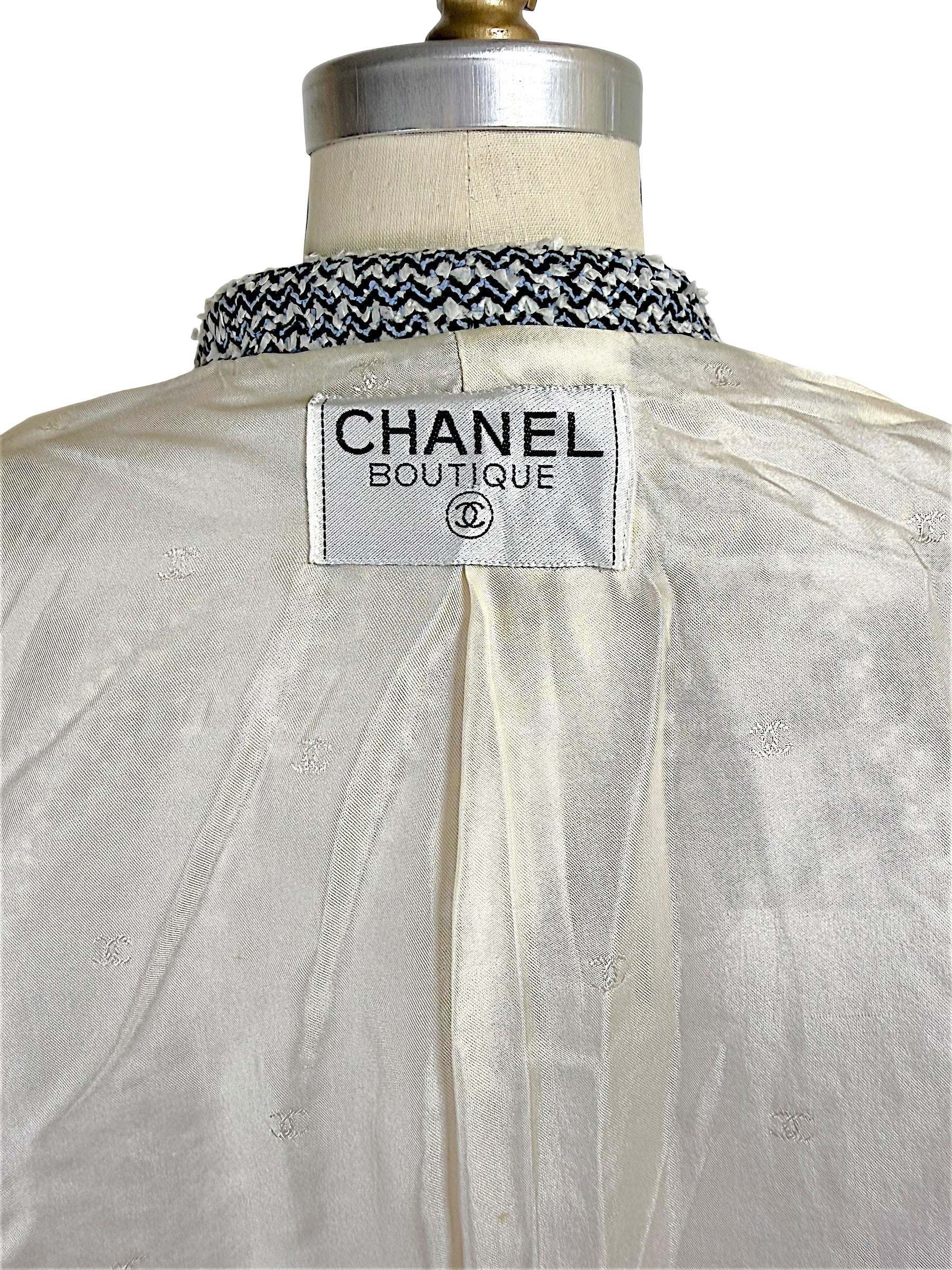 Interior Chanel Boutique label detail on ivory silk CC jacquard lining from Chanel Spring 1996 tweed jacket