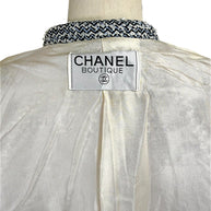 Interior Chanel Boutique label detail on ivory silk CC jacquard lining from Chanel Spring 1996 tweed jacket