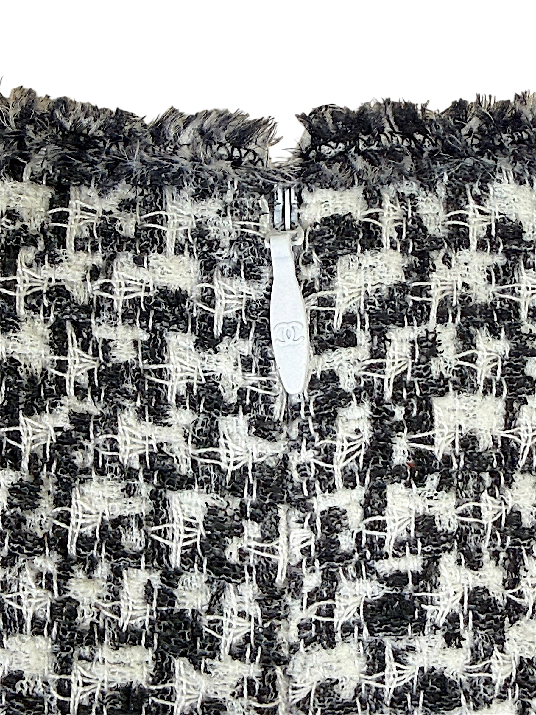 Chanel CC zipper pull detail on black and white tweed fabric