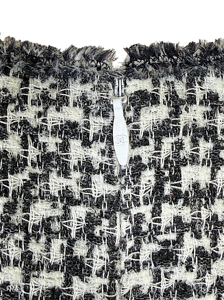 Chanel CC zipper pull detail on black and white tweed fabric