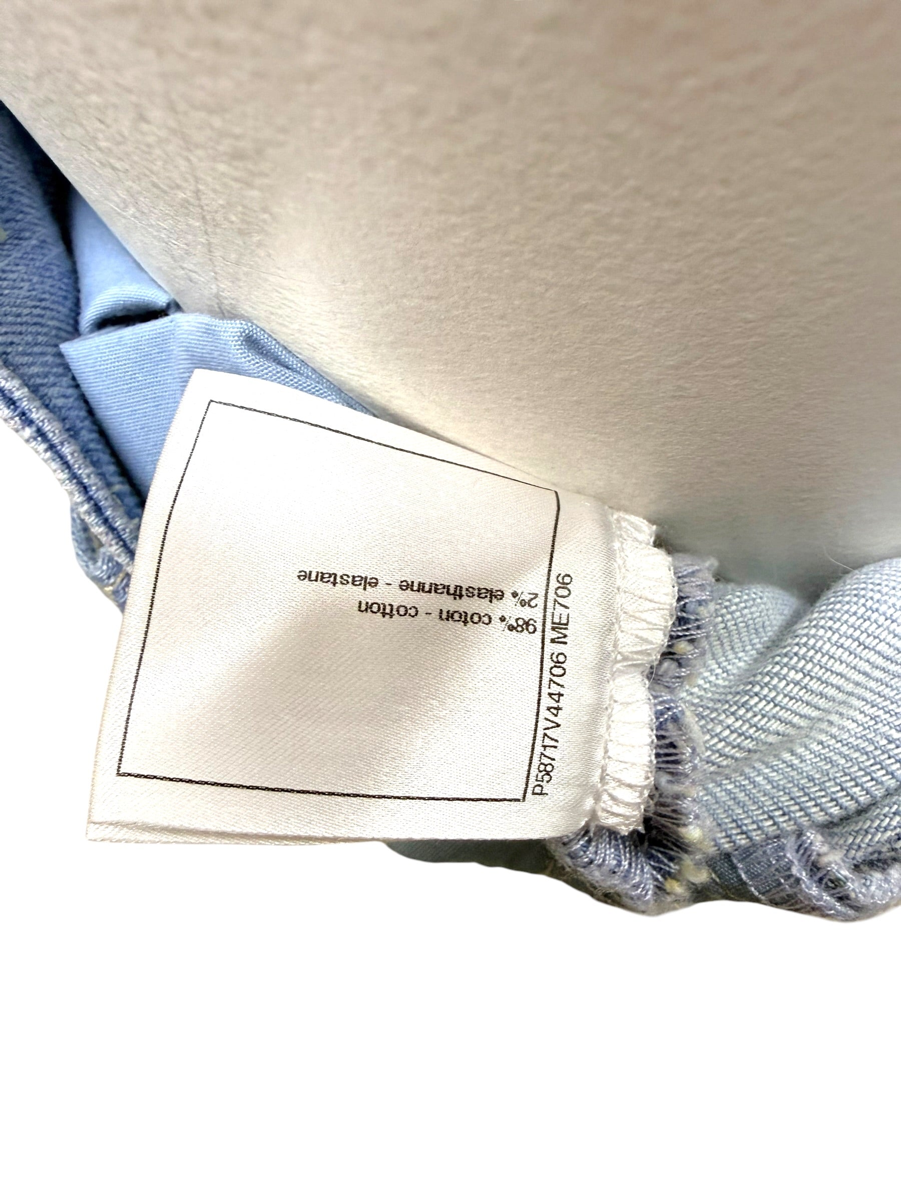 Chanel care and composition tag showing cotton and elastane blend for striped denim jeans.