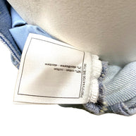 Chanel care and composition tag showing cotton and elastane blend for striped denim jeans.