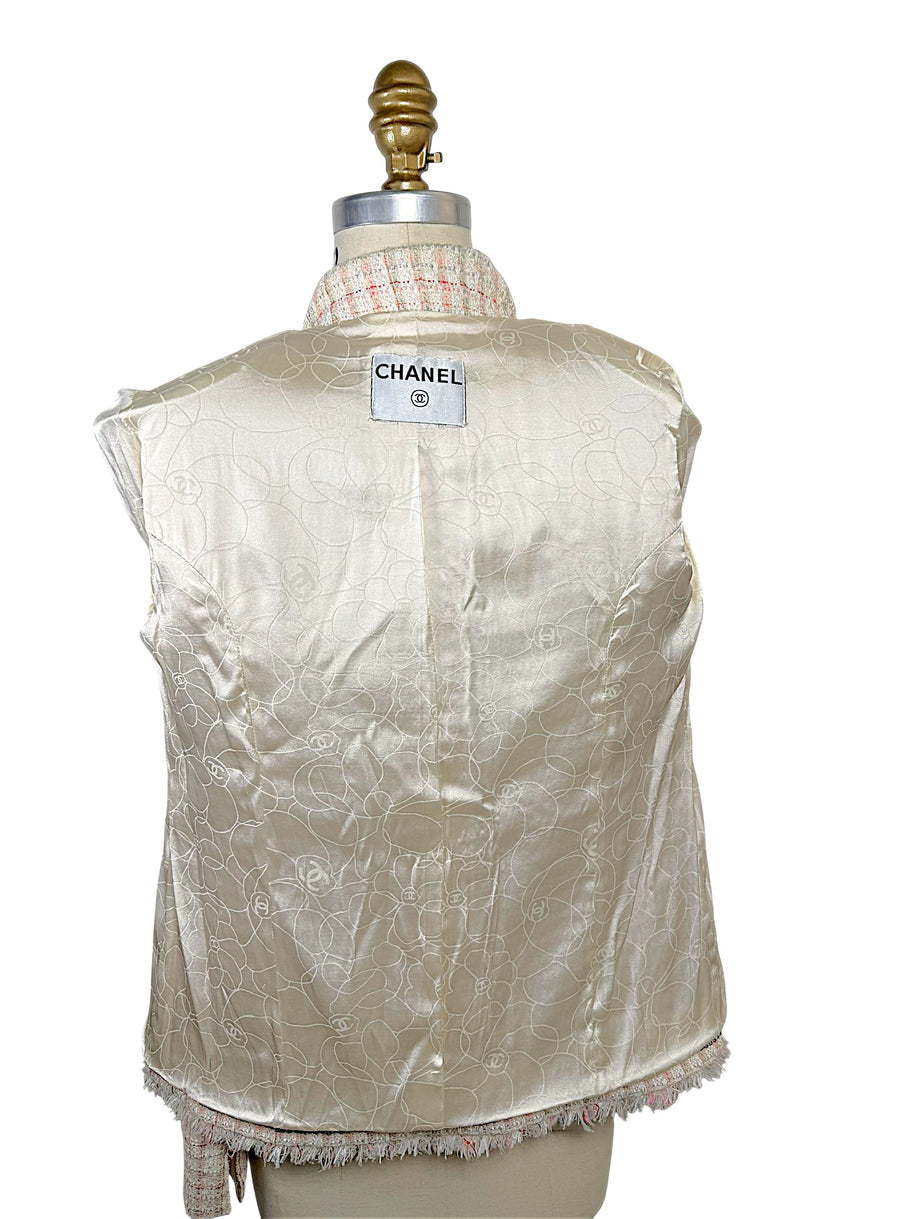 Interior of Chanel Cruise 2004 jacket featuring ivory silk lining woven with tonal camellia flowers and interlocking CC motifs.