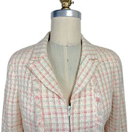 Close-up of Chanel Cruise 2004 fantasy tweed jacket showing textured ivory bouclé, concealed zip closure, frayed trim and tailored notched collar.