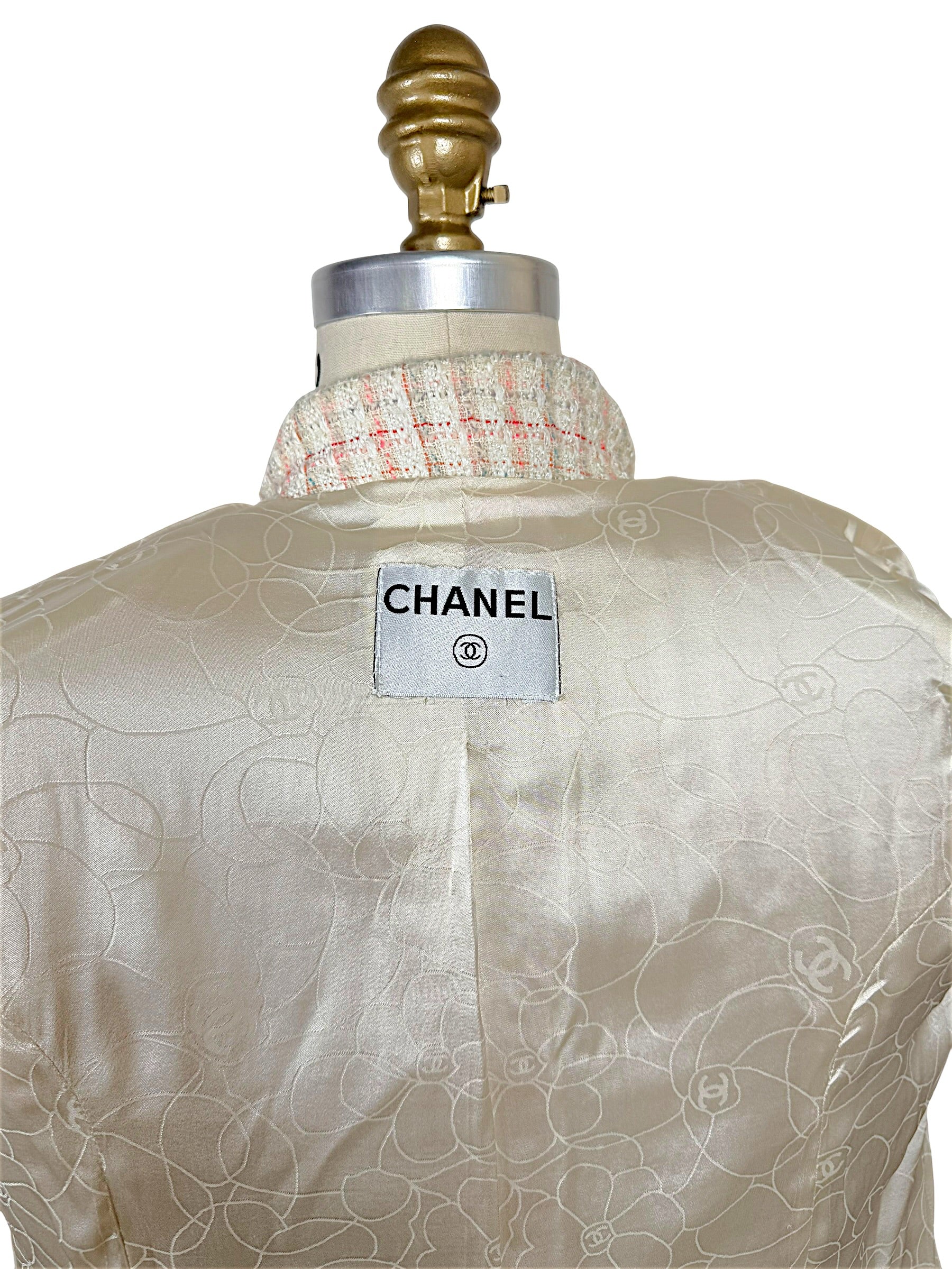 Close-up of authentic Chanel interior neck label on the Cruise 2004 fantasy tweed jacket with signature camellia jacquard silk lining.