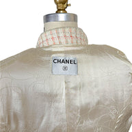 Close-up of authentic Chanel interior neck label on the Cruise 2004 fantasy tweed jacket with signature camellia jacquard silk lining.