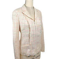 Three-quarter front view of Chanel Cruise 2004 ivory fantasy tweed jacket with hidden zip closure, patch pockets and textured bouclé weave.