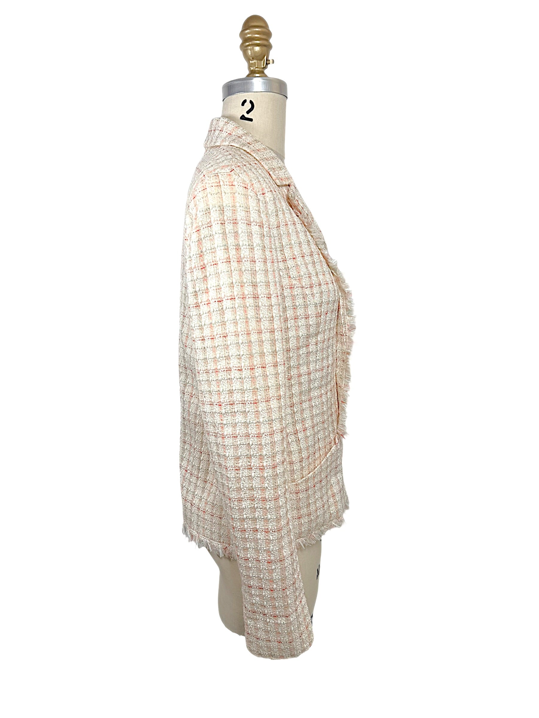 Side profile of Chanel Cruise 2004 ivory fantasy tweed jacket highlighting tailored silhouette, long sleeves and frayed hem detailing.