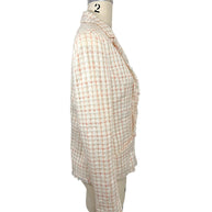 Side profile of Chanel Cruise 2004 ivory fantasy tweed jacket highlighting tailored silhouette, long sleeves and frayed hem detailing.