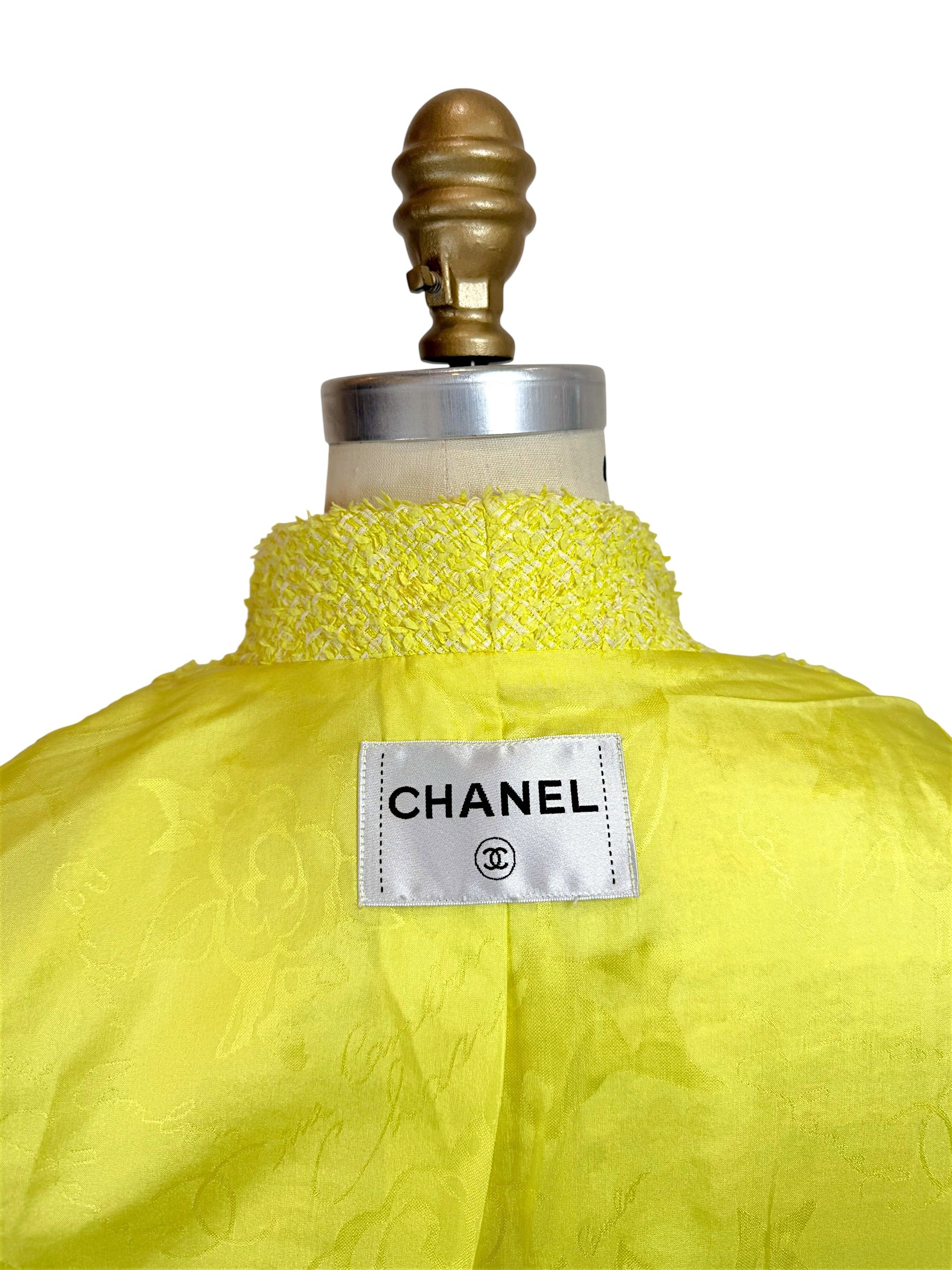 Close-up of Chanel neck label and yellow CC jacquard silk lining inside Cruise 2012 runway jacket