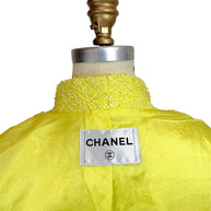 Close-up of Chanel neck label and yellow CC jacquard silk lining inside Cruise 2012 runway jacket