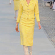 Chanel Cruise 2012 runway Look 1 featuring yellow bouclé tweed skirt suit designed by Karl Lagerfeld