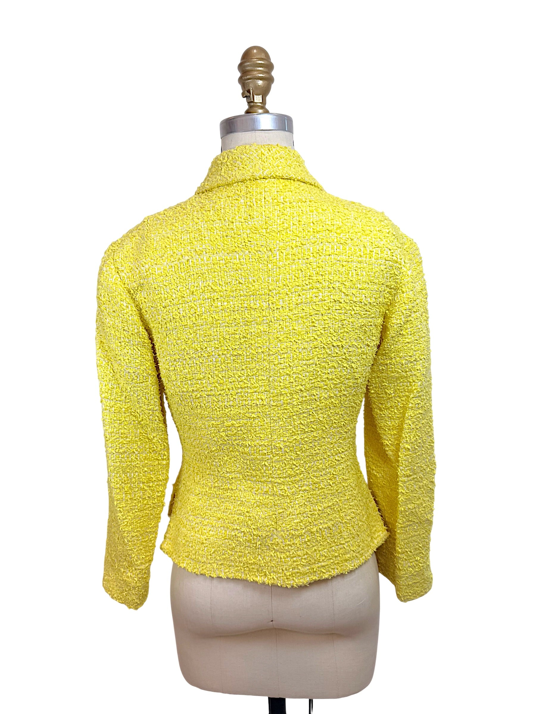 Back view of Chanel Cruise 2012 yellow bouclé tweed runway jacket with fitted silhouette and structured tailoring