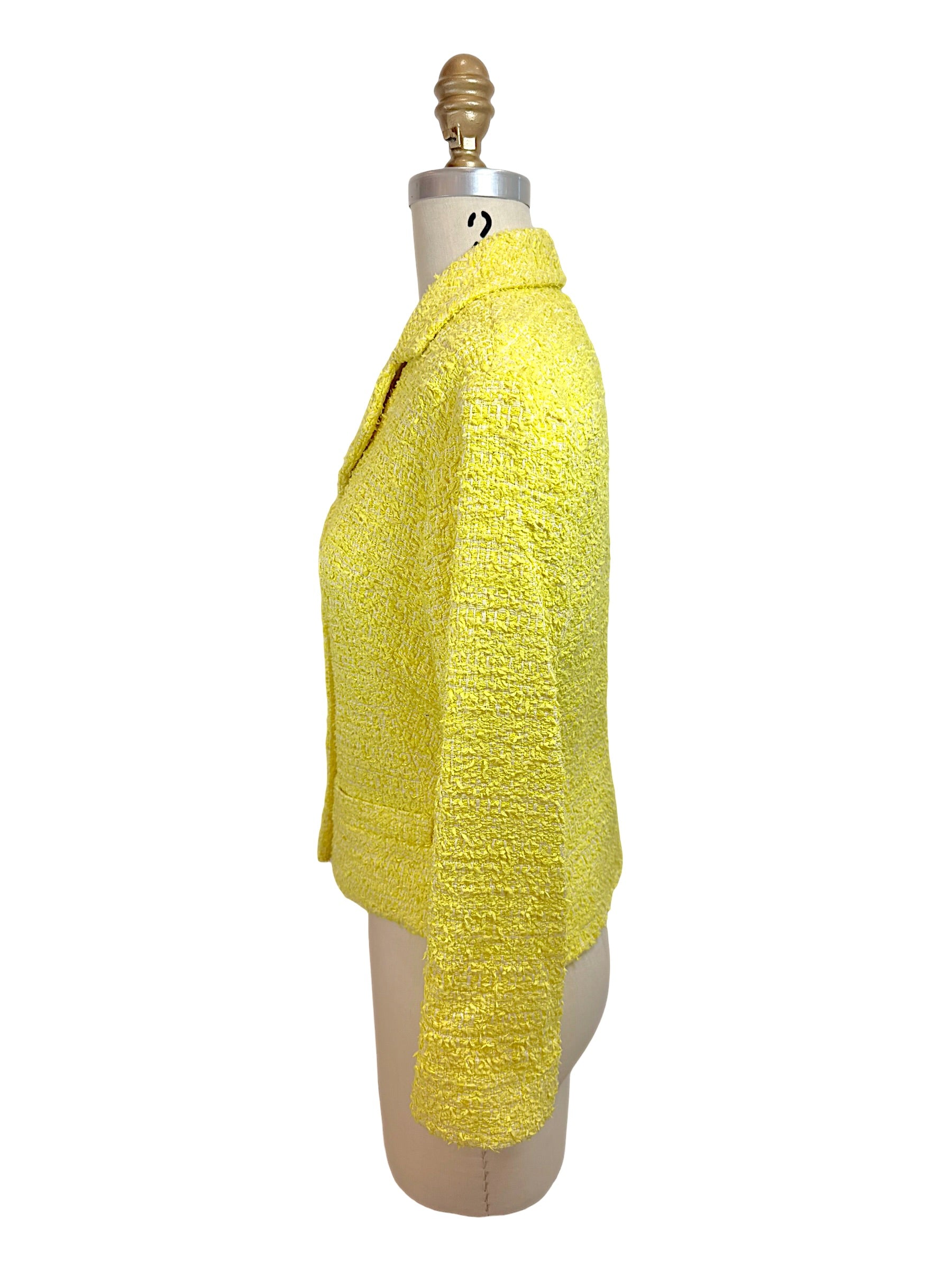 Side profile of Chanel Cruise 2012 yellow tweed fitted runway jacket with tailored waist and textured bouclé fabrication