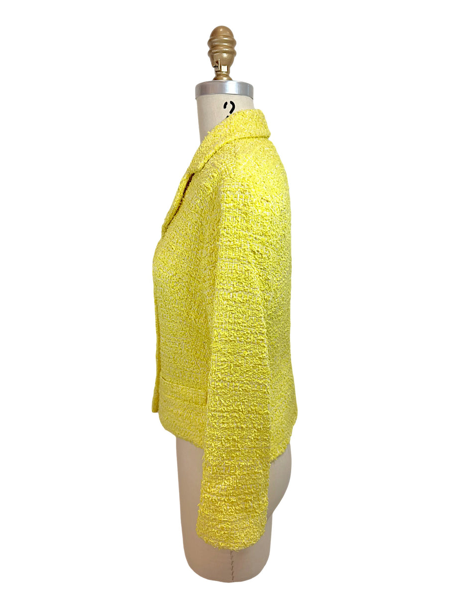 Side profile of Chanel Cruise 2012 yellow tweed fitted runway jacket with tailored waist and textured bouclé fabrication