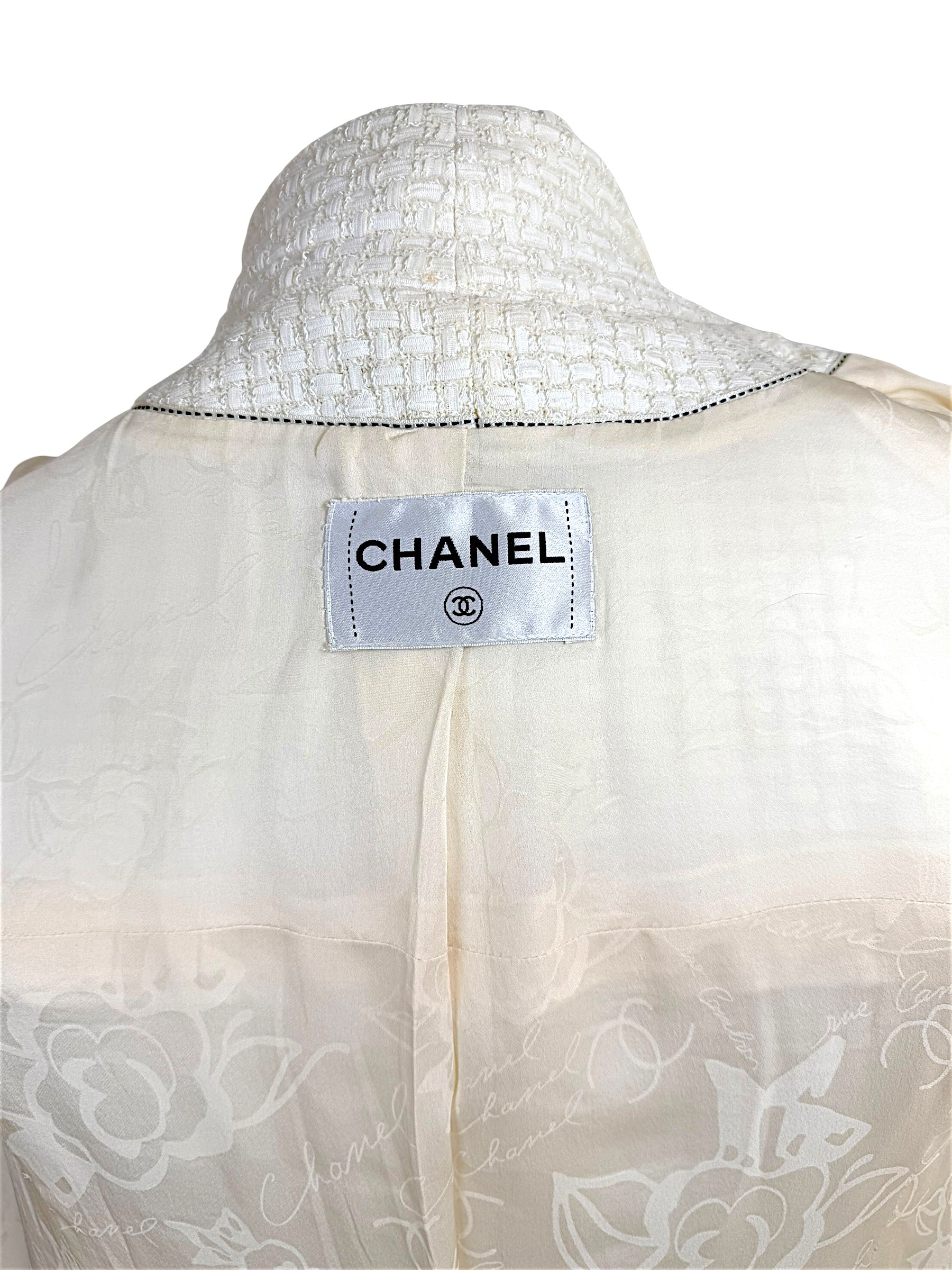 Interior Chanel label and camellia jacquard lining detail from Cruise 2014 ivory tweed jacket