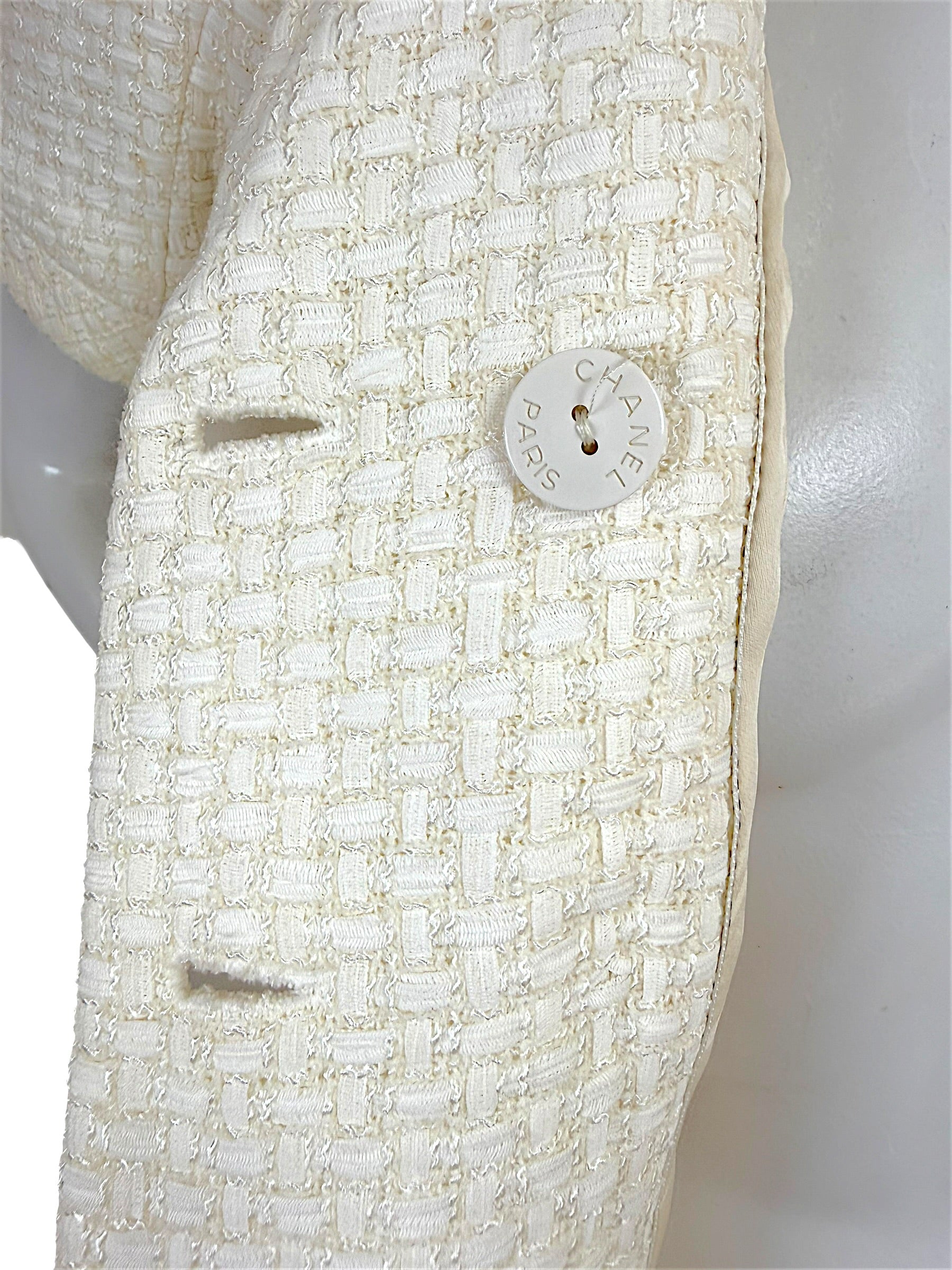 Detail image of Chanel Cruise 2014 ivory tweed fabric and Chanel Paris logo button