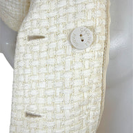 Detail image of Chanel Cruise 2014 ivory tweed fabric and Chanel Paris logo button