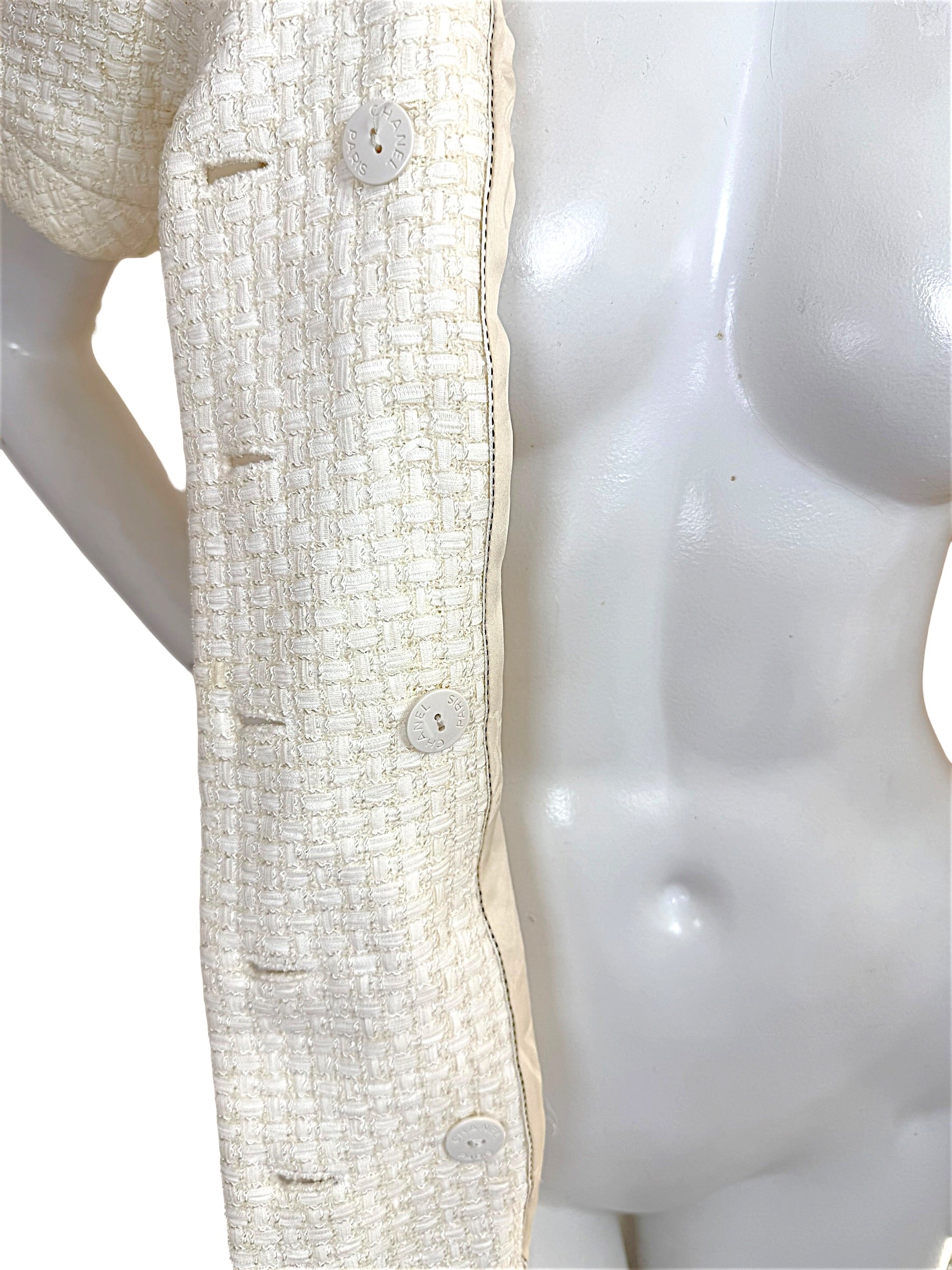 Close-up of Chanel Cruise 2014 ivory tweed jacket front placket and Chanel buttons