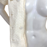 Close-up of Chanel Cruise 2014 ivory tweed jacket front placket and Chanel buttons