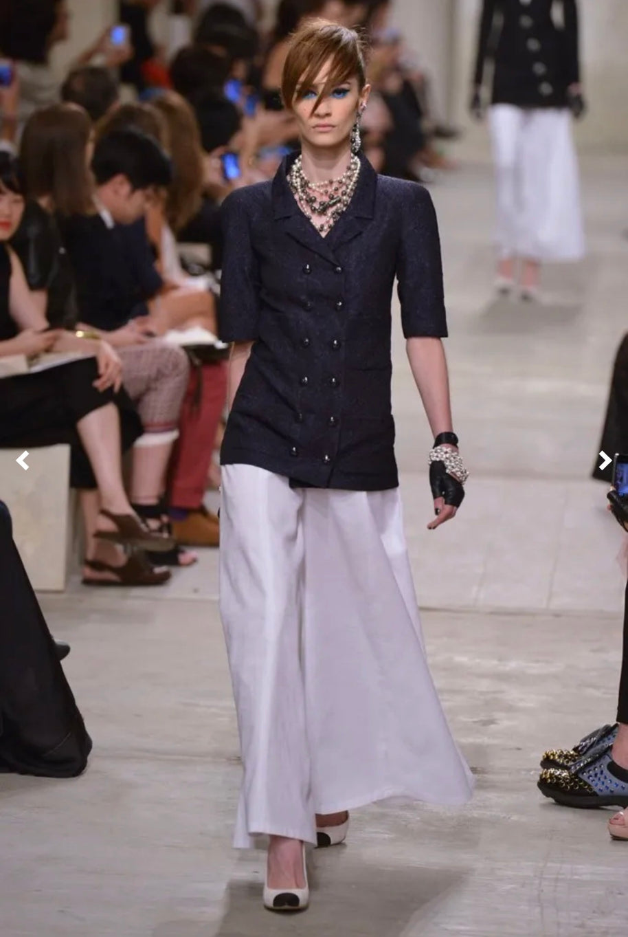 Runway reference showing Chanel Cruise 2014 Look 11 double-breasted textured tweed jacket in an alternate navy colorway, documenting the same design as the ivory jacket offered for sale.