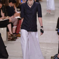 Runway reference showing Chanel Cruise 2014 Look 11 double-breasted textured tweed jacket in an alternate navy colorway, documenting the same design as the ivory jacket offered for sale.