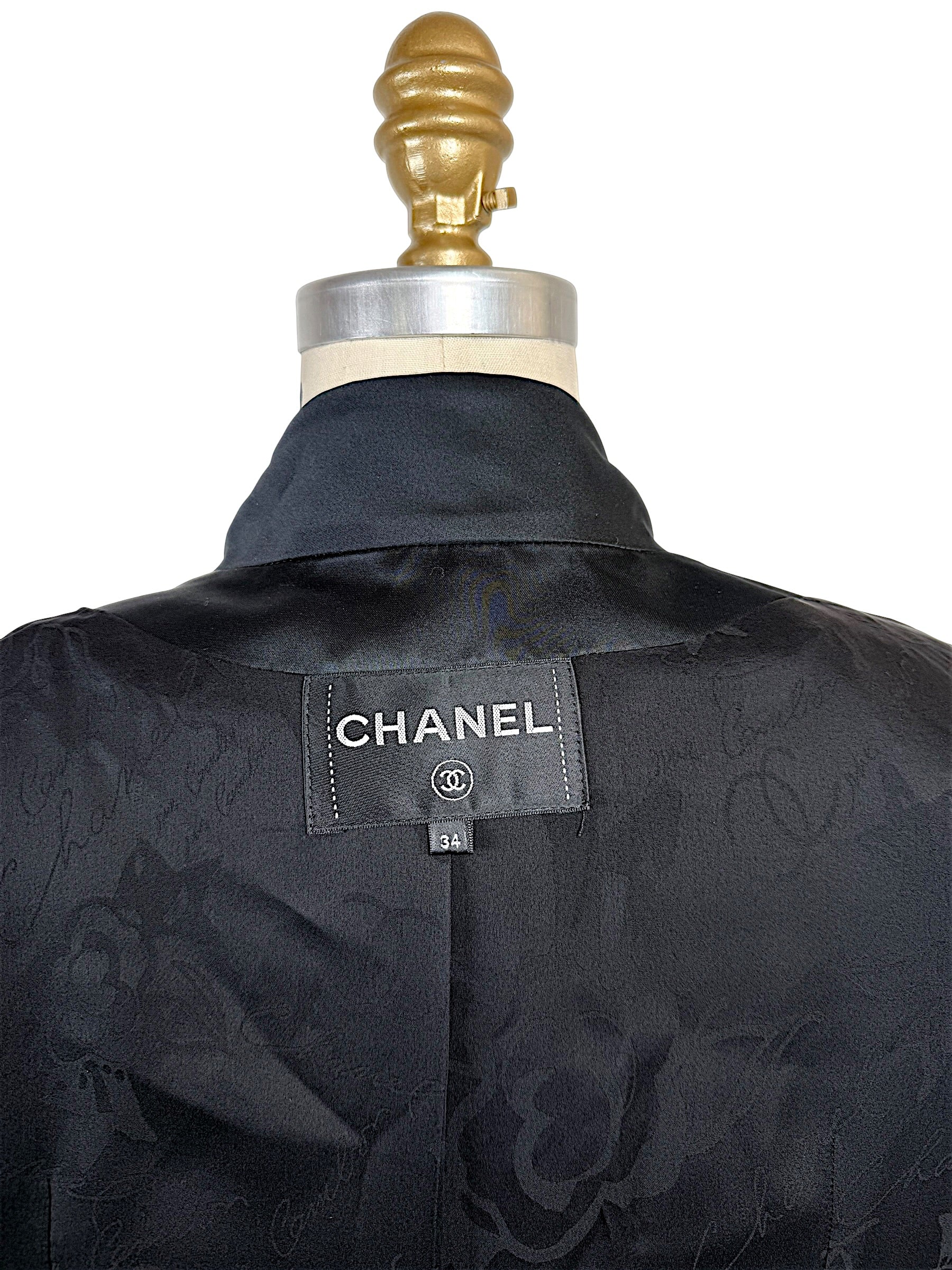 Interior view of the authentic Chanel Cruise 2017 jacket displaying the Chanel label, size 34 tag, and tonal CC jacquard silk lining.