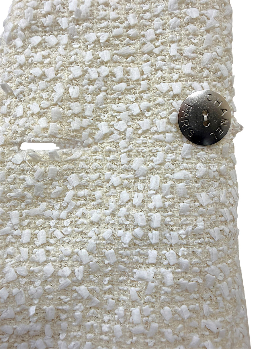 Interior silver-tone Chanel Paris logo button securing the front closure of the authentic Chanel Cruise 2019 Runway Look 26 ivory fantasy tweed jacket.
