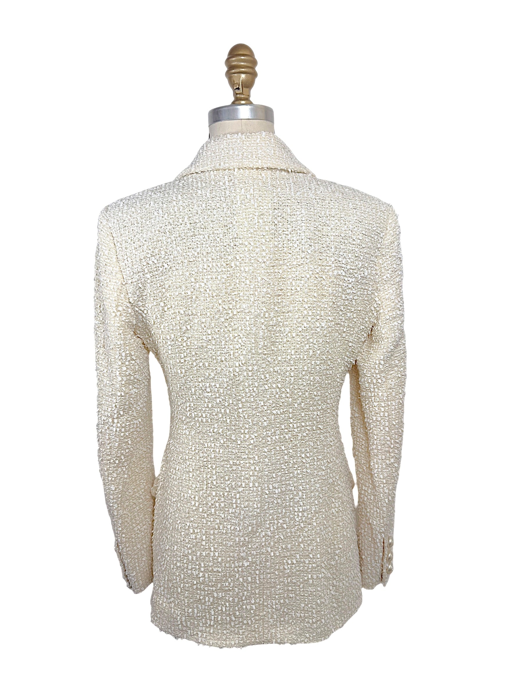 Rear view of the Chanel Cruise 2019 Runway Look 26 ivory fantasy tweed jacket showing clean tailoring, structured shoulders, and refined silhouette.
